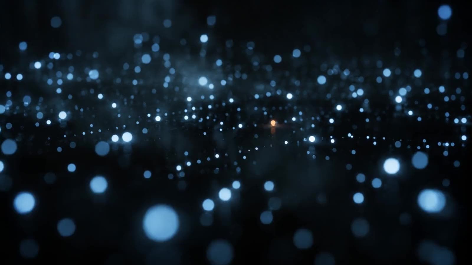 An abstract field of blue-white light in a dark space